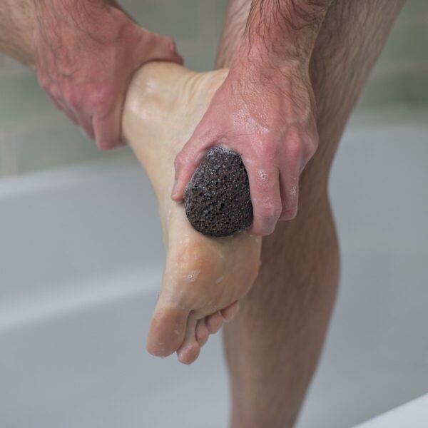 Demonstration on how to use a natural pumice stone to remove tough skin from your feet.